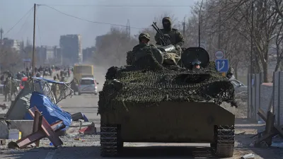 Tropas prorrusas con uniformes sin insignias conducían este sábado un vehículo blindado por Mariupol.